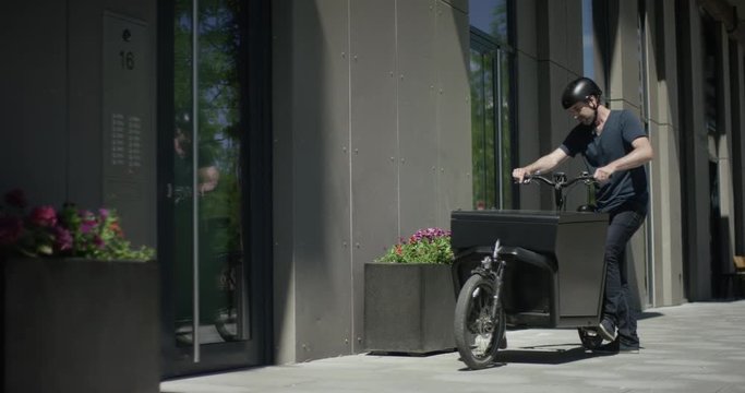 Male cycle messenger delivering packages
