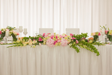 Wedding decorations, flowers and candles in restaurant. 