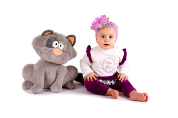 Cute little girl with a toy cat on a white background