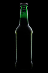 green bottle of beer, clipping path,on a black background, with brilliant edges and foam