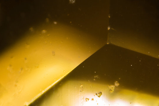 Yellow gem under the microscope