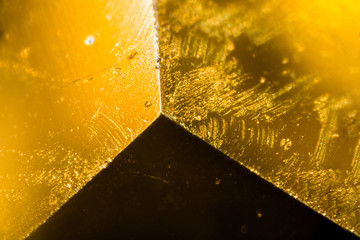 Yellow gem under the microscope