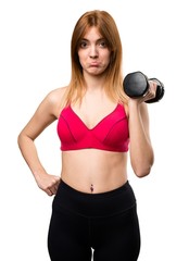 Sad beautiful sport woman with dumbbells