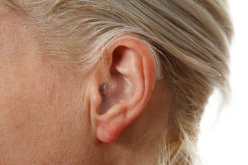 digital hearing aid in woman's ear