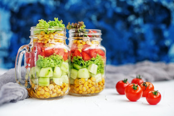 Vegetable delicious salad in a glass jar. Light breakfast. The concept is healthy food, diet, vegetarianism.