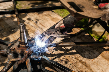 Man welding at his backyard