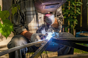 Man welding at his backyard