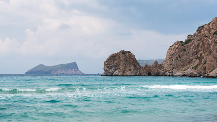 Plathiena, lovely beach with crystal blue waters on the northern side of Milos in Cloudy day. Cyclades, Greece.