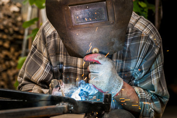Man welding at his backyard