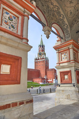 View on Moscow Red Square Kremlin tower Spasskaya Bashnya with Chiming Kuranti Clock through arch...