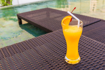 Orange juice on the table at the pool.