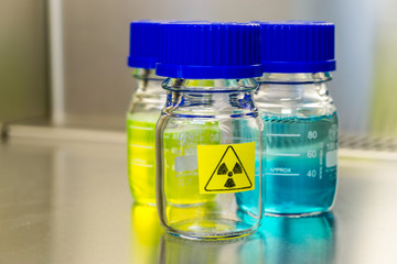 radioactice sample in a bottle in laboratory environment