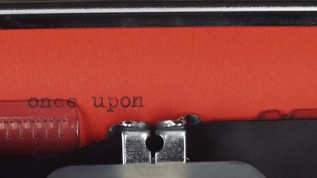 Once upon a time - Typed on a old vintage typewriter. Printed on red paper. The red paper is inserted into the typewriter