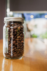 Coffee beans in vintage glass on table