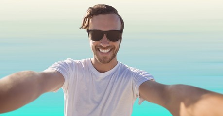 Man taking selfie against light blue background