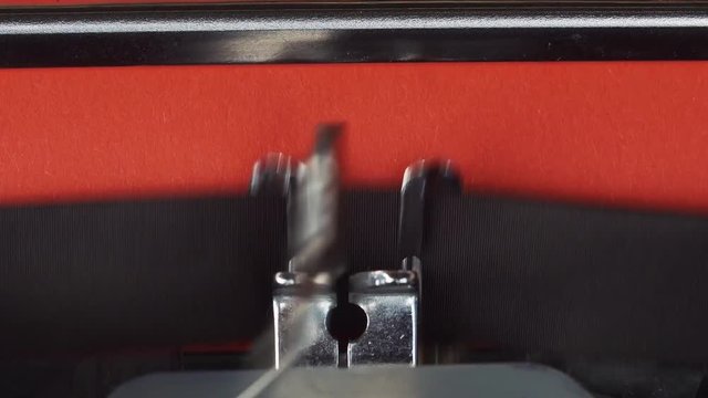 chapter 2 - Typed on a old vintage typewriter. Printed on red paper. The red paper is inserted into the typewriter