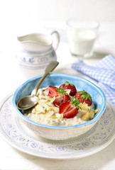 Oat porridge with fresh strawberry for a breakfast.