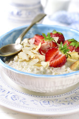 Oat porridge with fresh strawberry for a breakfast.