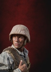 Fototapeta na wymiar Soldier man standing against red background