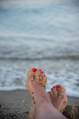 Female feet on the sandy beach