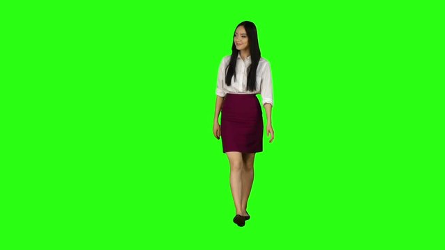 Girl looks around, chooses the right things for herself. Green screen. Slow motion