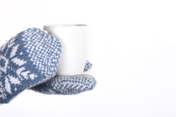  winter mittens around a mug 