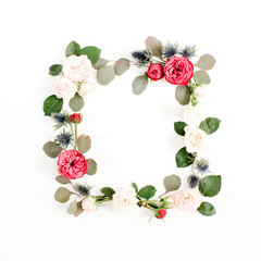 Round frame wreath made of red and beige rose flower buds, eucalyptus branches and leaves isolated on white background. Flat lay, top view. Floral background