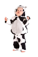 A baby in a fancy dress cow costume on a white background