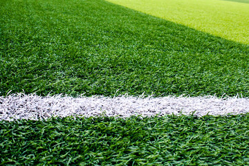 The white Line marking on the artificial green grass soccer field