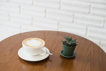 Latte art coffee on wooden table