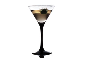 Cocktail martini with olive, a splash of vermouth in a glass