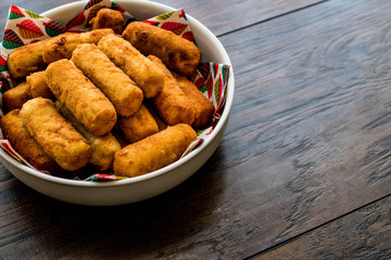 Potato croquettes (croquetas) on wooden surface.