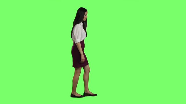 Girl hurries to the negotiations, she does not have time. Green screen. Slow motion