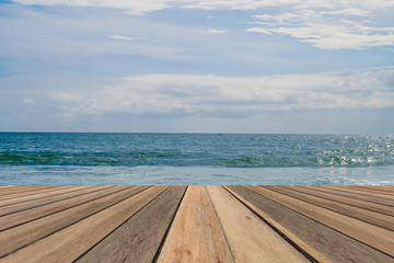 Wooden table on beach sea sky background