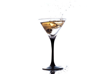 Cocktail martini with olive, a splash of vermouth in a glass