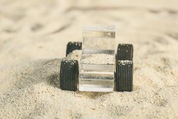 Transparent Methacrylate toy car in the sand