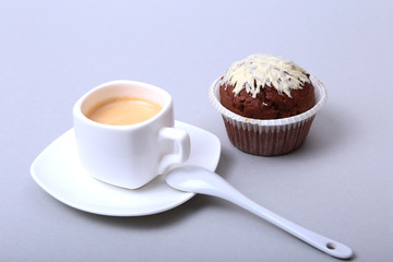 Classic espresso in white cup with homemade cake and chocolate on white background.