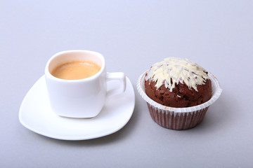 Classic espresso in white cup with homemade cake and chocolate on white background.