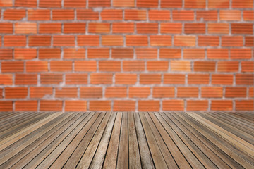 Wooden table on brick wall background