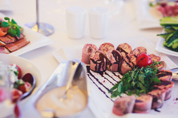 Decorated catering banquet table with different food appetizers assortment on a party
