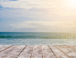 Wooden table with sea, sky and beach background