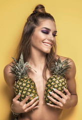 Young crazy girl with pineapples.