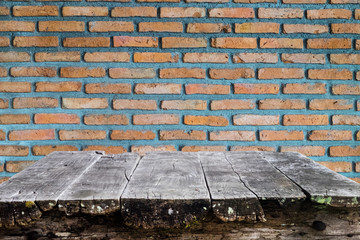 Wooden table on brick