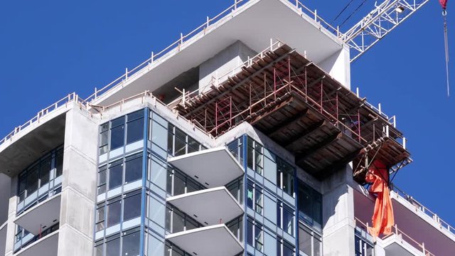 Tilt shot of construction of new high-rise building in city with 4k resolution