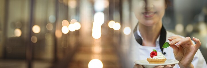 Chef holding dessert tart with elegant blurry lights transition