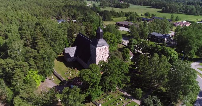Korppoo, Cinema 4k aerial landing tilt view of a church in Korpo town, on a sunny summer day, in the finnish archipelago outside Turku, Varsinais-suomi, Finland