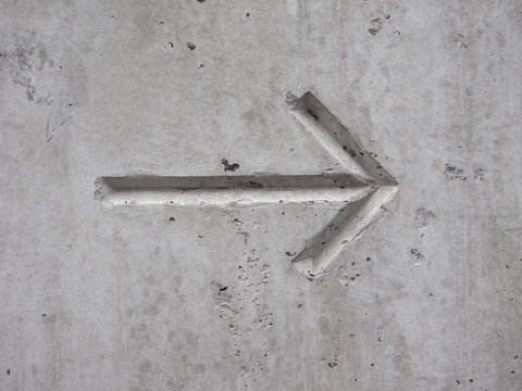 arrow on concrete - Powered by Adobe