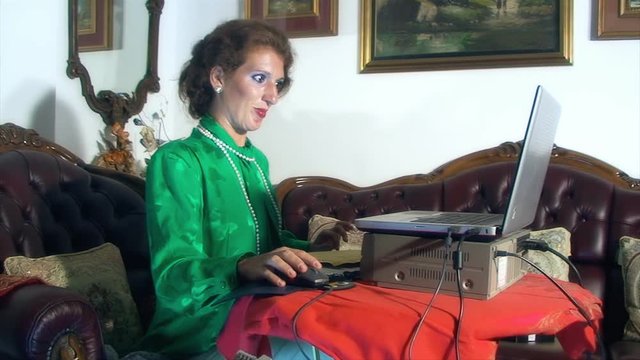 A harsh lady watching a vhs tape at home, becoming interested in the footage.
