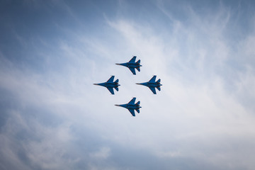 Team of four  pilots make complex aerobatics figure on su-27  fighter
