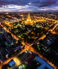 Large golden pagoda Located in the community at sunset , Phra Pathom Chedi , Nakhon Pathom , Thailand .The measure public.Aerial view road roundabout with car lots in Thailand.Beautiful street.